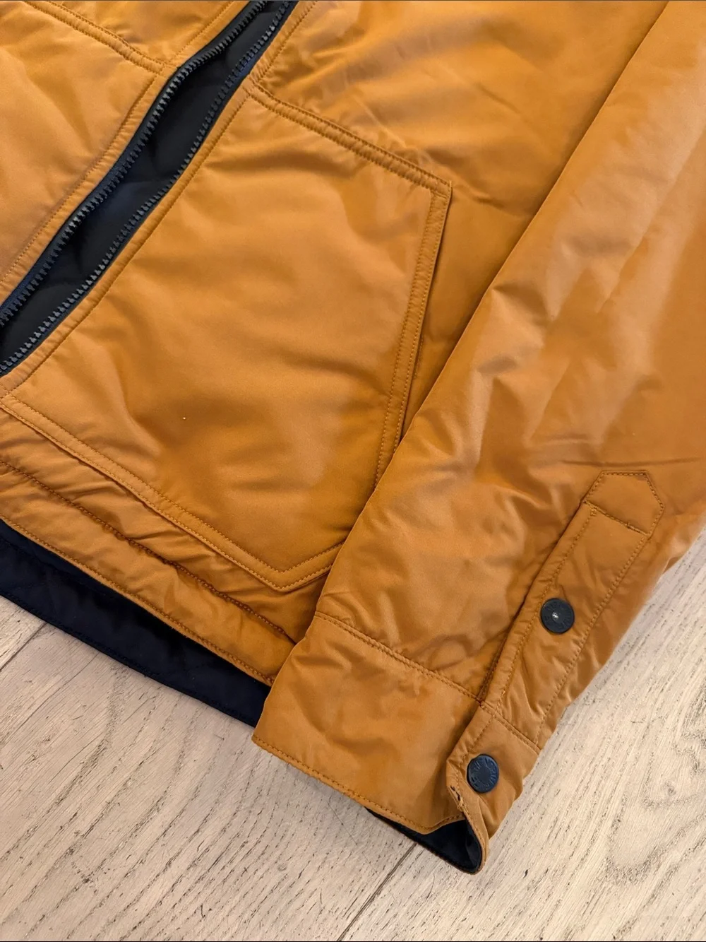 The North Face Men's Quilted Bomber Jacket in Black with Mustard reversible